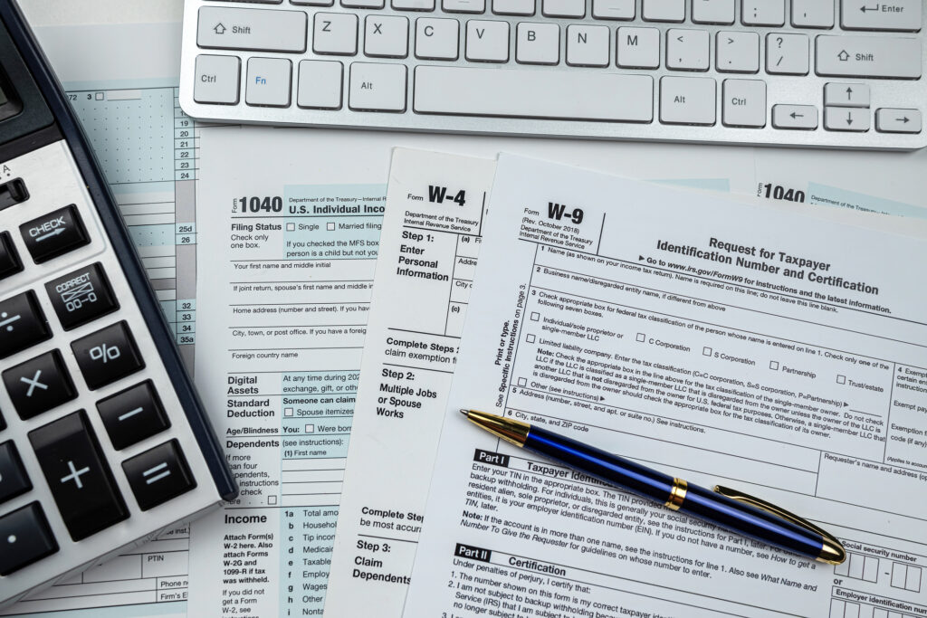 2022 blank 1040 us tax form with calculator and keyboard on office desk. Financial accounting concept